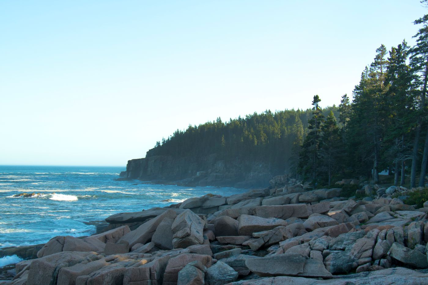 Waves breaking on the rocky Acadia coastline at sunrise